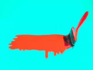 Kwast met druipende rode verf op turquoise achtergrond